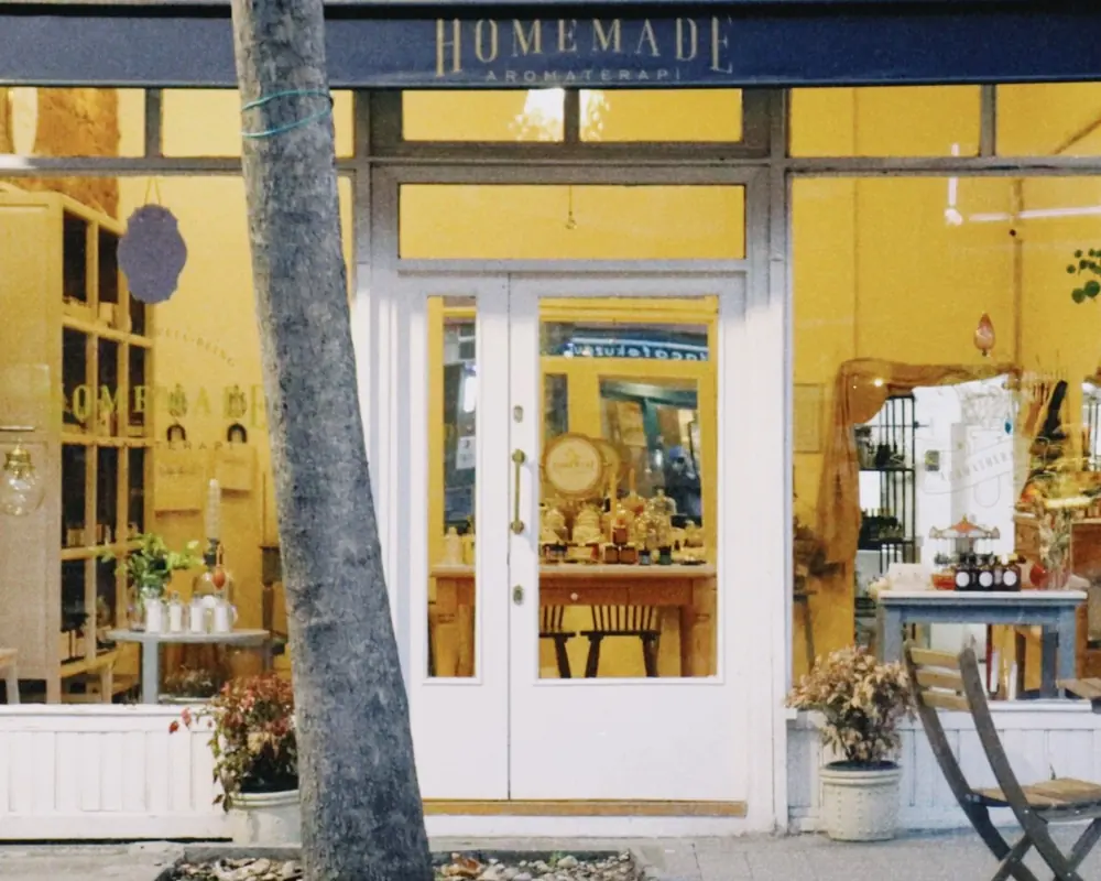 A small independent storefront with an awning on a quiet street