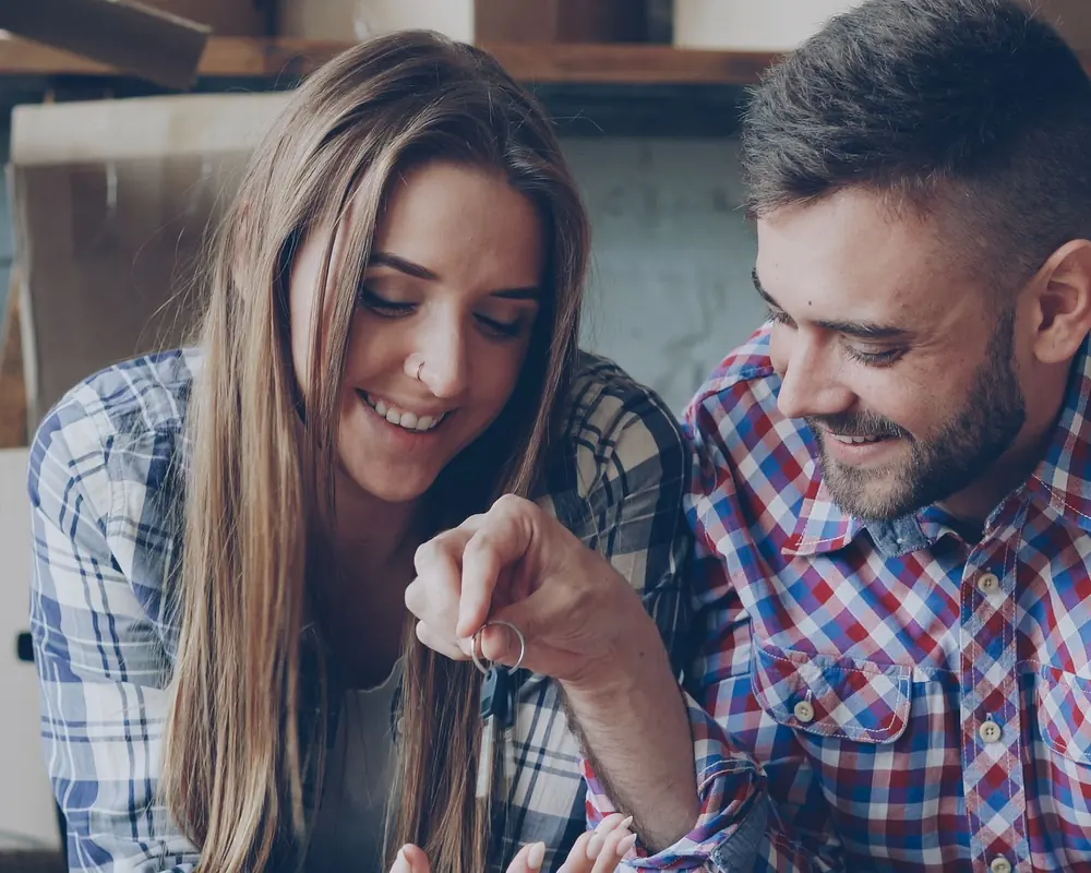 A couple admiring the key to their new home