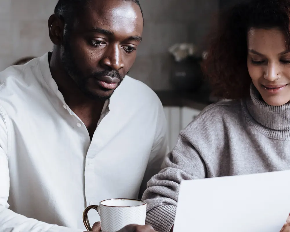 A couple reviewing paperwork together at home